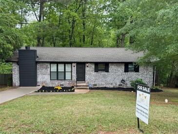 Charming, freshly painted, one-story home with manicured lawn and flower beds in a desirable location at 7994 Devonshire Dr, Jonesboro, GA 30238
