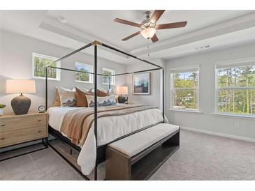 Spacious primary bedroom with large canopy bed and ample natural light from multiple windows at 3136 Washburn Se St, Atlanta, GA 30354