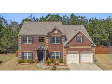 Beautiful two-story brick home with a two-car garage and meticulously kept landscaping at 403 Sonja Ln, Loganville, GA 30052