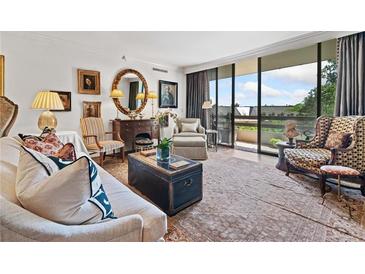 Spacious living room with hardwood floors, elegant furnishings, and access to a private balcony at 2660 Peachtree Rd # 6A, Atlanta, GA 30305