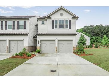 Charming two-story townhouse with a two-car garage and well-maintained landscaping at 3848 Hester St, Duluth, GA 30097