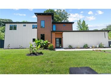 Stunning modern home with a mix of wood and white siding, complemented by lush green landscaping at 5370 Greenleaf Sw Dr, Mableton, GA 30126