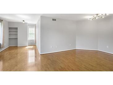 Spacious living room featuring hardwood floors and contemporary lighting at 199 14Th Ne St # 402, Atlanta, GA 30309