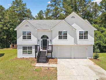 Charming two-story home with a well-maintained lawn, front-facing garage and classic curb appeal at 3156 Ozmer Lndg, Decatur, GA 30034