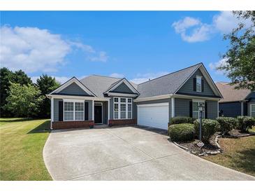 Charming single-story home with a well-manicured lawn, complemented by a spacious driveway and an attached garage at 3634 Cape Ln, Conyers, GA 30013