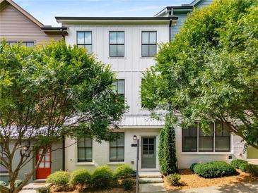 Charming two-story white brick home with lush green landscaping and large windows at 752 Winton Way, Atlanta, GA 30312