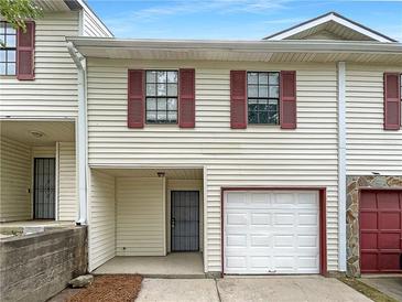 Charming townhome featuring an attached garage and red window shutters at 3008 Pine Tree Trl # 16D, Atlanta, GA 30349