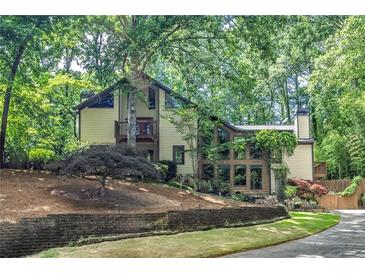 Two-story home with a lush, wooded lot and mature landscaping for ultimate privacy and curb appeal at 4655 Latimer Ne Ct, Kennesaw, GA 30144