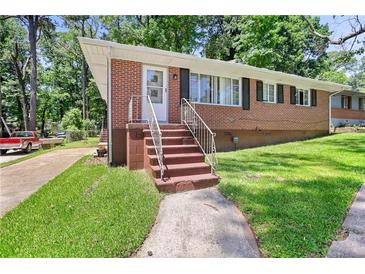 Charming brick ranch-style home featuring a well-maintained lawn and mature trees at 2215 Springdale Sw Rd, Atlanta, GA 30315