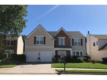 Charming two-story home with a well-manicured lawn and a two-car garage on a sunny day at 3692 Ramsey Cir, Atlanta, GA 30331