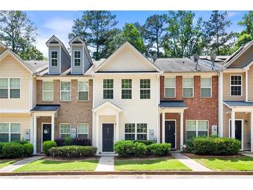 Charming townhouse with neat landscaping and inviting front entrance at 420 Berckman Nw Dr, Lilburn, GA 30047