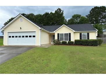Charming single-story home with manicured lawn, attached garage, and welcoming curb appeal at 929 Wexford Way, Auburn, GA 30011