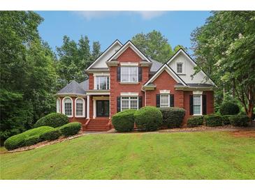 Charming brick home with manicured lawn and mature trees in a well-kept neighborhood at 315 Glengarry Chase, Covington, GA 30014