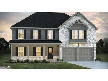 Two-story home featuring a welcoming front porch, gray color palette, and a two-car garage at 1672 Fuma Leaf Way, Mcdonough, GA 30252