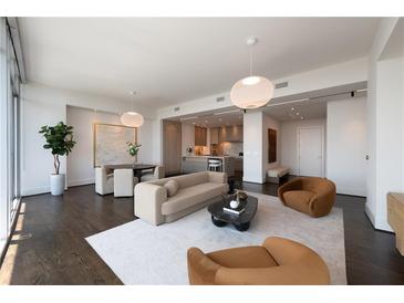 Bright open-concept living room featuring a dining area and stylish kitchen with modern appliances at 1065 Peachtree Ne St # 3504, Atlanta, GA 30309