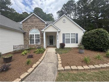 Charming home with stone accents, manicured landscaping, and a welcoming walkway at 2840 Alcovy River Vw, Dacula, GA 30019