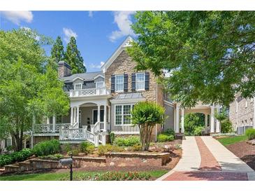 Charming stone and siding home with a covered front porch, porte-cochere, and beautifully landscaped front yard at 3903 Hazelhurst Dr, Marietta, GA 30066