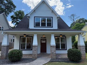 Charming home with a covered front porch, brick accents, and inviting curb appeal at 339 Morgan Se Pl, Atlanta, GA 30317