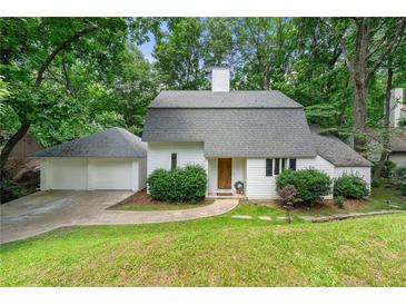 Charming home with a well-maintained lawn, mature trees, and a two-car garage at 4018 Dunbarton Ne Way, Roswell, GA 30075