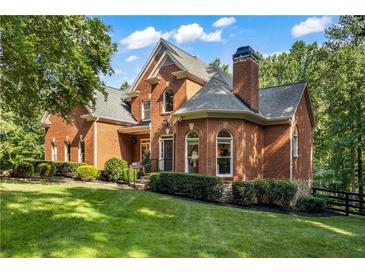 Charming two-story brick home with a well-manicured lawn and mature trees in a desirable neighborhood at 110 Wellington Way, Canton, GA 30115