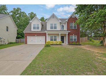 Charming two-story home with a brick and siding exterior, a well-manicured lawn, and an attached two-car garage at 6341 Stewart Ridge Walk, Buford, GA 30518