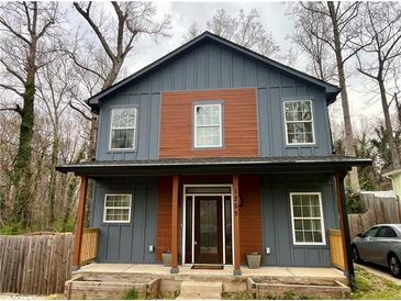 Charming two-story home featuring a modern blue exterior with a covered front porch at 1255 Plaza Sw Ave, Atlanta, GA 30310