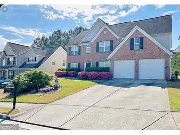 Charming brick home with two-car garage and well-maintained landscaping at 665 Roxford Ln, Buford, GA 30518