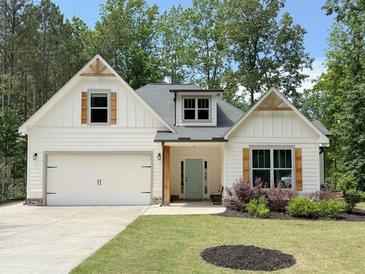 Charming one story home with a white exterior, complimented by wood accents and a well-manicured lawn at 3455 Henderson Dr, Cumming, GA 30041