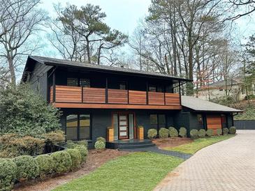 Beautiful black two-story home with a wooden balcony and well-maintained landscaping at 4601 Tall Pines Nw Dr, Atlanta, GA 30327