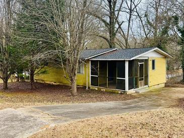 Charming single-story home featuring a cozy screened-in porch, mature trees and a paved driveway at 1101 Isa Se Dr, Atlanta, GA 30315