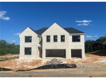 New construction of a two-story brick home featuring a two-car garage and classic architectural details at 4437 Hosch Reserve Ct, Buford, GA 30519