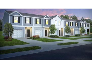 Modern townhome exteriors feature individual garages, symmetrical windows, and well-manicured landscaping at 9470 Cedar Grove Ct # 236, Jonesboro, GA 30238