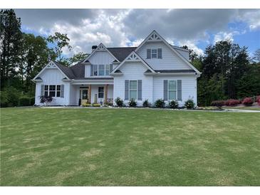 Charming two-story home with white siding, grey shutters, and a well-manicured front lawn at 605 Red Leaf Way, Canton, GA 30114