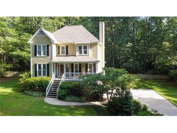Aerial view of a house with a well-manicured lawn and mature trees at 51 Vienna Way, Douglasville, GA 30134