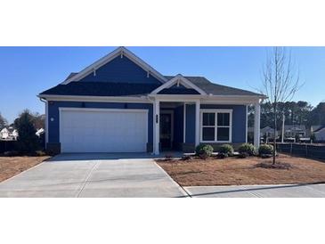 Charming blue home featuring a two-car garage and well-manicured landscaping at 199 Vinca Nw Cir, Kennesaw, GA 30144