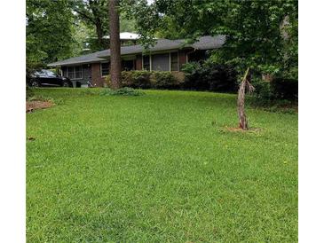 Charming single-story home nestled on a lush green lawn with mature trees at 2493 Springdale Rd, Atlanta, GA 30315