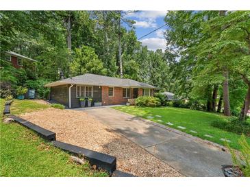 Charming single-story home with a brick facade and well-manicured lawn at 2493 Springdale Rd, Atlanta, GA 30315