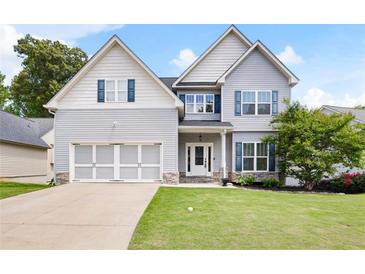 Charming two-story home with light gray siding, white trim, blue shutters, and well-manicured lawn at 1016 Buckeye Ln, Villa Rica, GA 30180