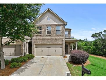Charming brick-front home featuring a two-car garage, manicured lawn, and lovely landscaping at 2396 Whiteoak Se Bnd # 16, Smyrna, GA 30080