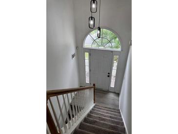 Inviting entryway with natural light and modern lighting fixtures at 5709 Newnan Cir, Austell, GA 30106
