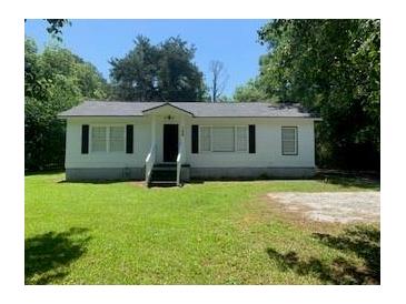 Charming one-story house with a well-maintained front lawn and classic architectural details at 106 E Wade St, Oxford, GA 30054