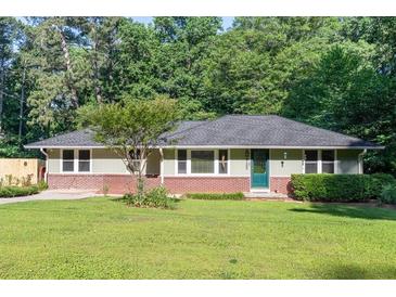 Charming single story home with a well-manicured lawn and mature trees offering shade at 2100 Shady Ln, Tucker, GA 30084