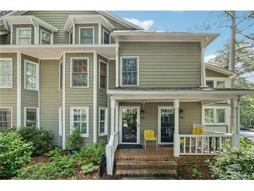 Charming townhome featuring a welcoming front porch and lush landscaping at 1416 Oakridge Cir, Decatur, GA 30033