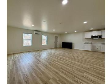 Spacious living room featuring wood floors, recessed lighting, and mini split AC at 3836 Saddle Hill Way, Douglasville, GA 30135
