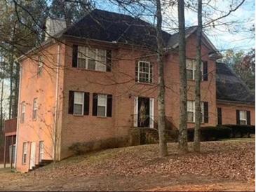 A charming two-story brick home with a well-maintained front yard and mature trees at 3796 Melvin Sw Dr, Atlanta, GA 30331
