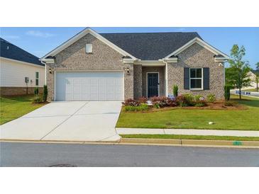 Charming single-story brick home featuring an attached two-car garage and well-manicured front lawn at 740 Pineberry Ct, Grayson, GA 30017