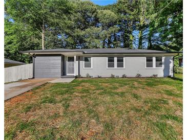 Charming single-story home featuring a modern gray brick facade and well-manicured lawn at 1770 Atherton Dr, Decatur, GA 30035