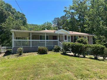 Charming brick home with a covered porch and manicured lawn, perfect for curb appeal at 3551 Skyline Sw Ter, Marietta, GA 30008