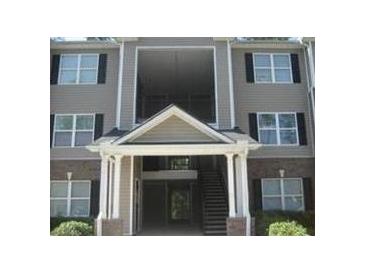 Well-maintained apartment building featuring a welcoming entrance and traditional architectural details at 8202 Fairington Village Dr, Lithonia, GA 30038