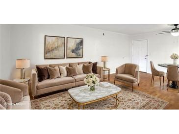 Elegant living room featuring a plush sofa, stylish decor, and ample natural light at 1150 Collier Nw Rd # K9, Atlanta, GA 30318